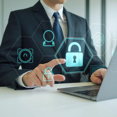 Professional in a suit interacting with advanced digital security icons on a laptop screen, representing expert cyber security services in Austin TX.